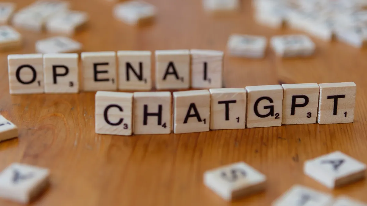 Best free AI article generators (no-cost tools compared) — AI Terminology in Letter Tiles on Wooden Desk