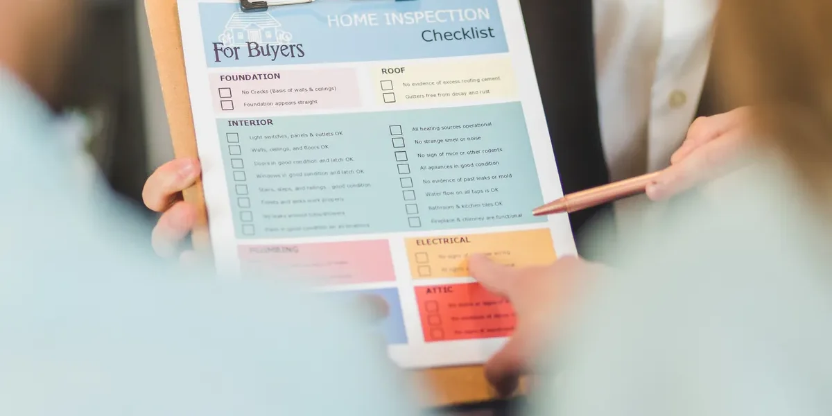 person holding a buyers checklist on a clipboard